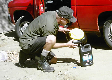 pouring used oil into container